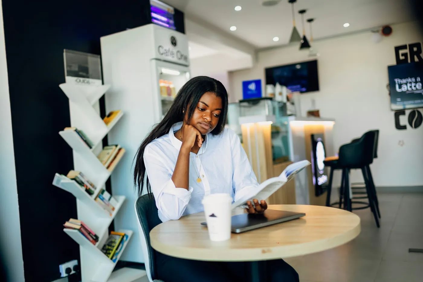 A customer working on a laptop at a café table